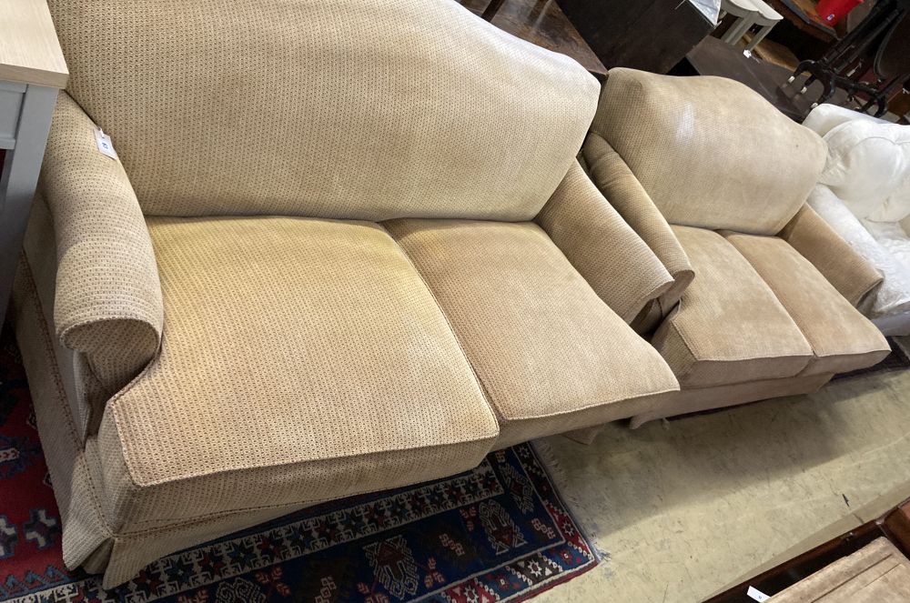 A pair of contemporary beige upholstered two seater settees, width 180cm depth 106cm max height 80cm